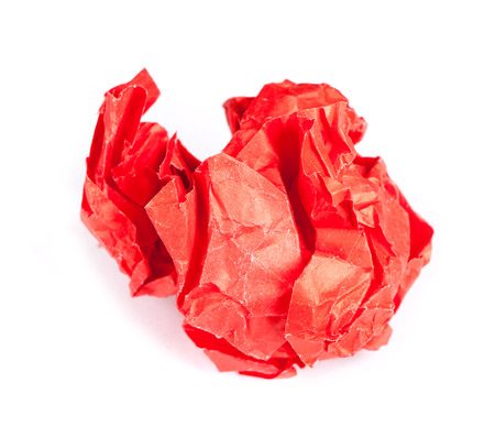 Screwed up piece of red paper isolated on white backgroundの写真素材