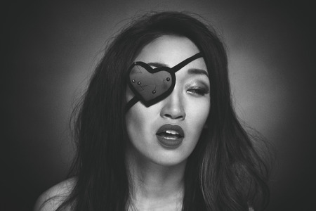 Beautiful woman with heart shape eye patchの写真素材