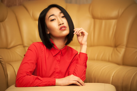 Portrait of asian woman in red shirtの写真素材