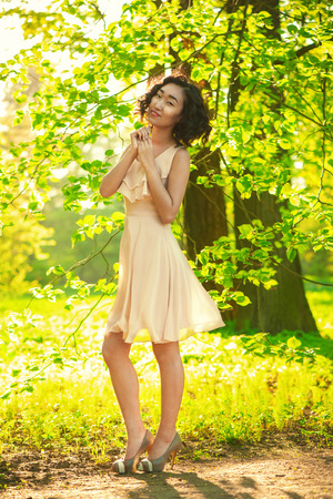 Woman in beautiful dress in parkの写真素材