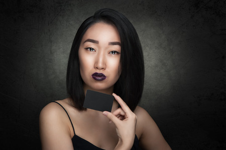Asian woman hold black empty cardの写真素材