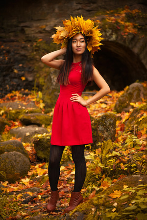 Asian woman with wreath of maple leavesの写真素材