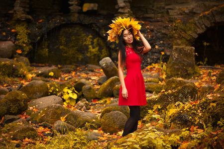 Asian woman with wreath of maple leavesの写真素材