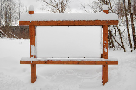 Wooden empty poster with snow outdoorsの写真素材