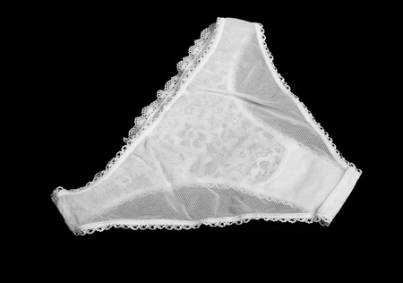 White lace underpants on black background