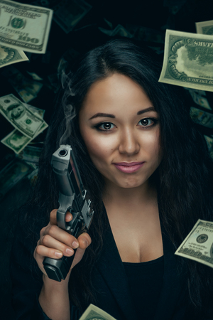 Sexy robber woman with pistolの写真素材