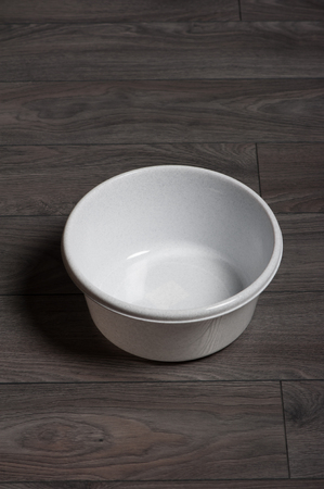 Clean white washbowl on dark laminateの写真素材