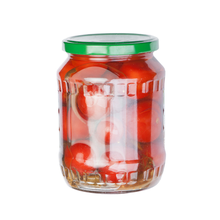 Jar of pickled tomatoes isolated on white backgroundの写真素材