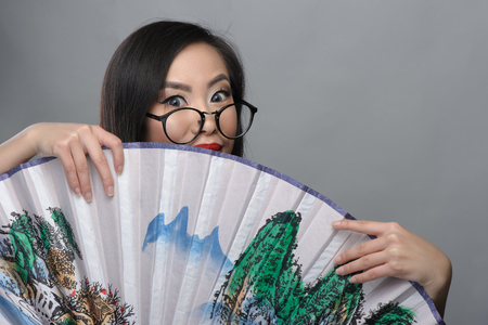 Portrait of beautiful young asian girl with glasses in white blouseの写真素材