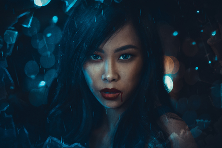 Fantasy portrait of young woman at night rainの写真素材