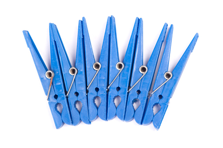 Blue plastic clothespins isolated on white backgroundの写真素材