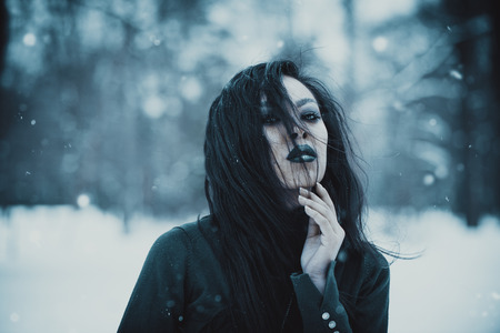 Asian gothic goth girl at snowy winter outdoorsの写真素材