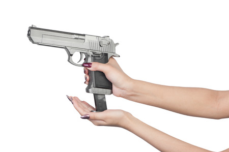 Pistol in female hand isolated on white backgroundの写真素材