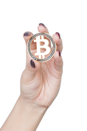 Female hand hold gold Bitcoin cryptocurrency isolated on white backgroundの写真素材