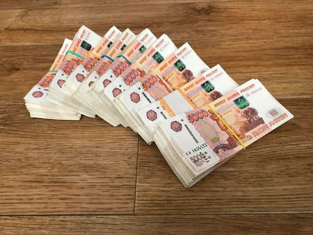 Stack of bills in packs of Russian ruble money on the floor