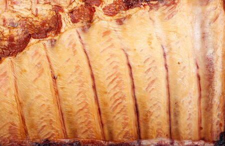 Smoked pork ribs for background close upの写真素材