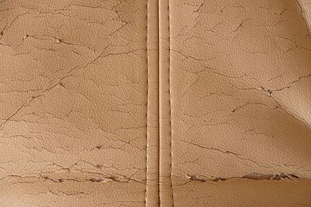 Cracked beige leather texture. Background in bad condition.の写真素材