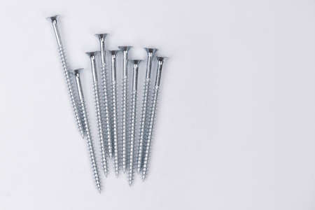Group of new long screws on a white background