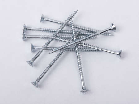 Group of new long screws on a white background
