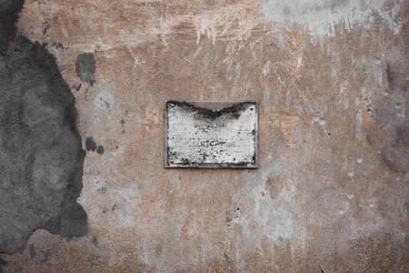 Old shabby plaque on the wall, antique backgroundの写真素材