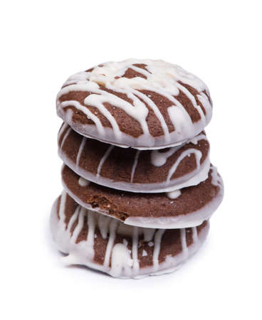 Group of chocolate cookies drizzled with white icing on isolated backgroundの写真素材
