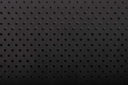 Black perforated plastic texture, surface with dots