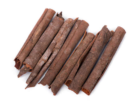 Original pieces of cinnamon sticks isolated on white backgroundの写真素材
