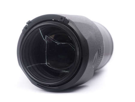 Broken protective filter glass on DSLR camera lens isolated over white backgroundの写真素材