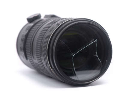 Broken protective filter glass on DSLR camera lens isolated on white backgroundの写真素材