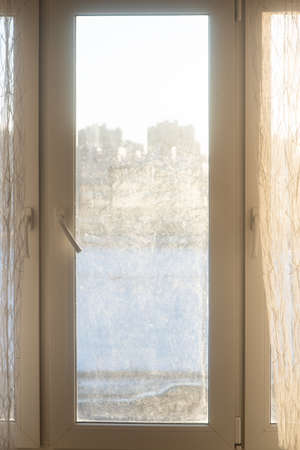 Window from the inside with a view of the sunny streetの写真素材
