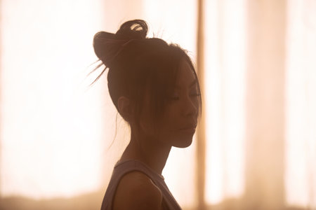 Silhouette of young asian woman, simple portraitの写真素材
