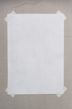 Blank paper taped on the wall by sticky tapeの写真素材