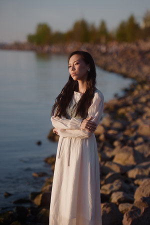 Portrait of candid woman in vintage dress outdoorsの写真素材
