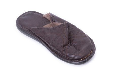Old worn leather slippers isolated on white backgroundの写真素材