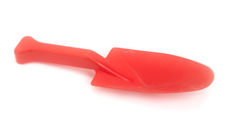Red children's plastic spade isolated on white backgroundの写真素材