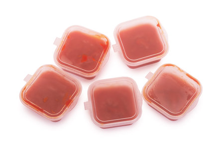 Group of ketchup containers isolated over white backgroundの写真素材