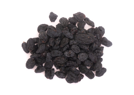 Bunch of black raisins isolated against white backgroundの写真素材