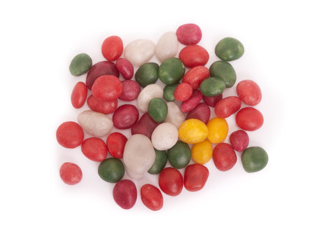 Heap of glazed dragee candies isolated over white backgroundの写真素材