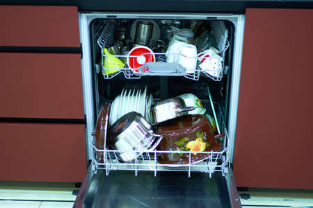 dishes lie in the dishwasher in the kitchen technology