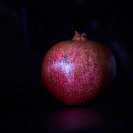 Pomegranate on a black background. Shallow depth of field.の写真素材