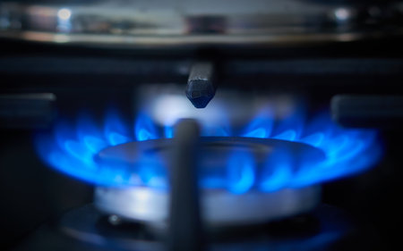 Gas burner with blue flames in the kitchen. Selective focus.の写真素材