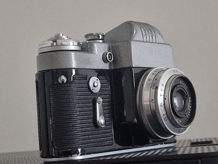 The old 35 mm SLR camera Soviet on a gray background.