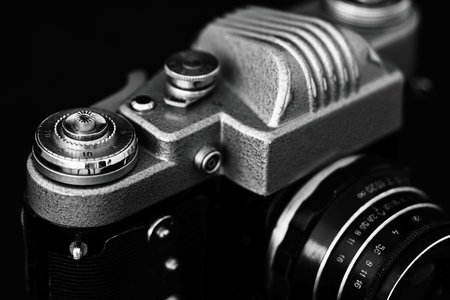 Retro camera on a black background. Selective focus. Shallow depth of field.の写真素材