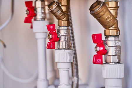 Water pipes and valves in a boiler room. Selective focus.