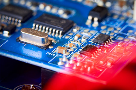 Close up of electronic circuit board with microchips and capacitors