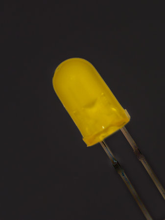 Yellow LED diode isolated on black background. Close-up.の写真素材