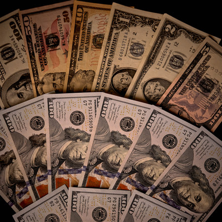 money background - close up of us dollar banknotes on red background