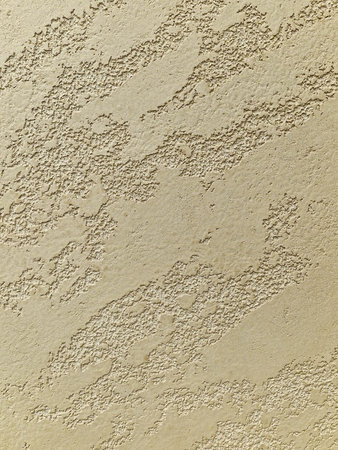 Texture of old rustic wall covered with beige stuccoの写真素材