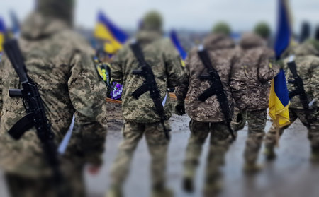 Soldiers on the background of the flag of Ukraine. Selective focus.