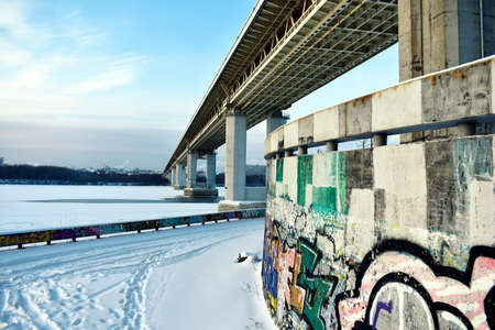 road bridge over the frozen river in winter